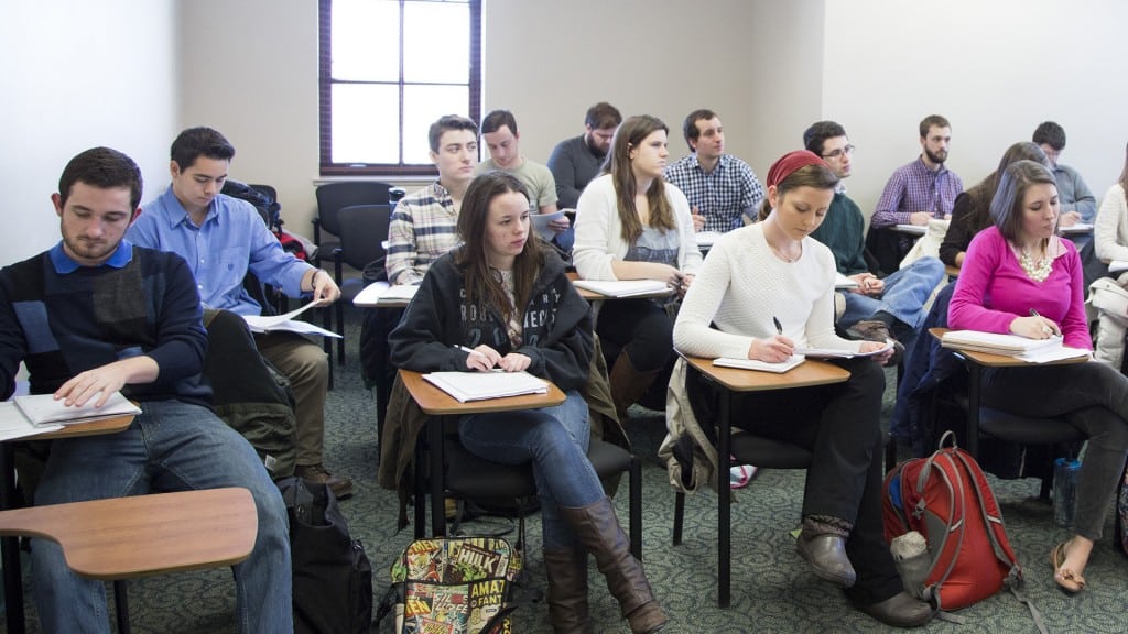 Students taking notes during an Economics class.