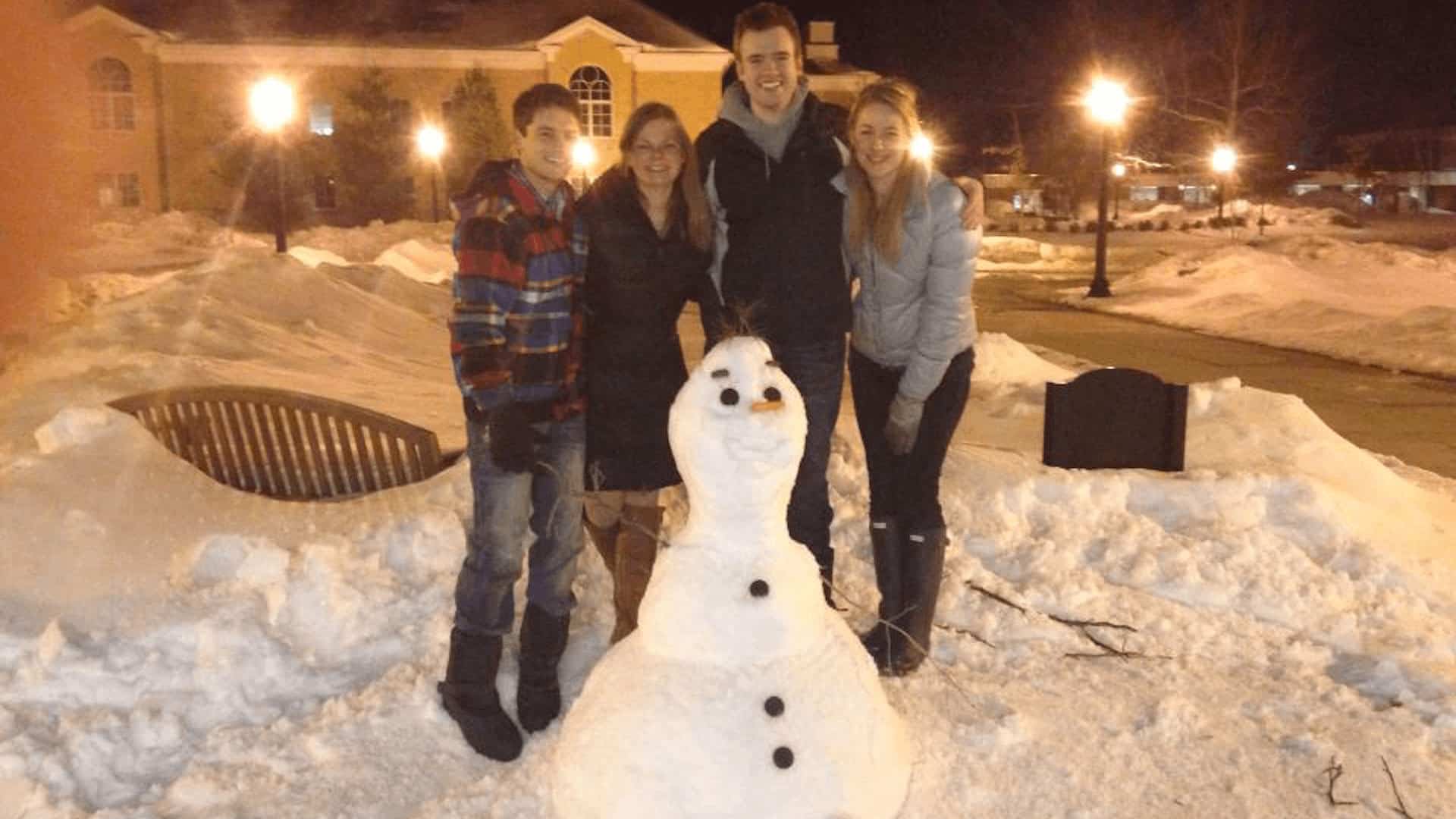 students with snowman on quad