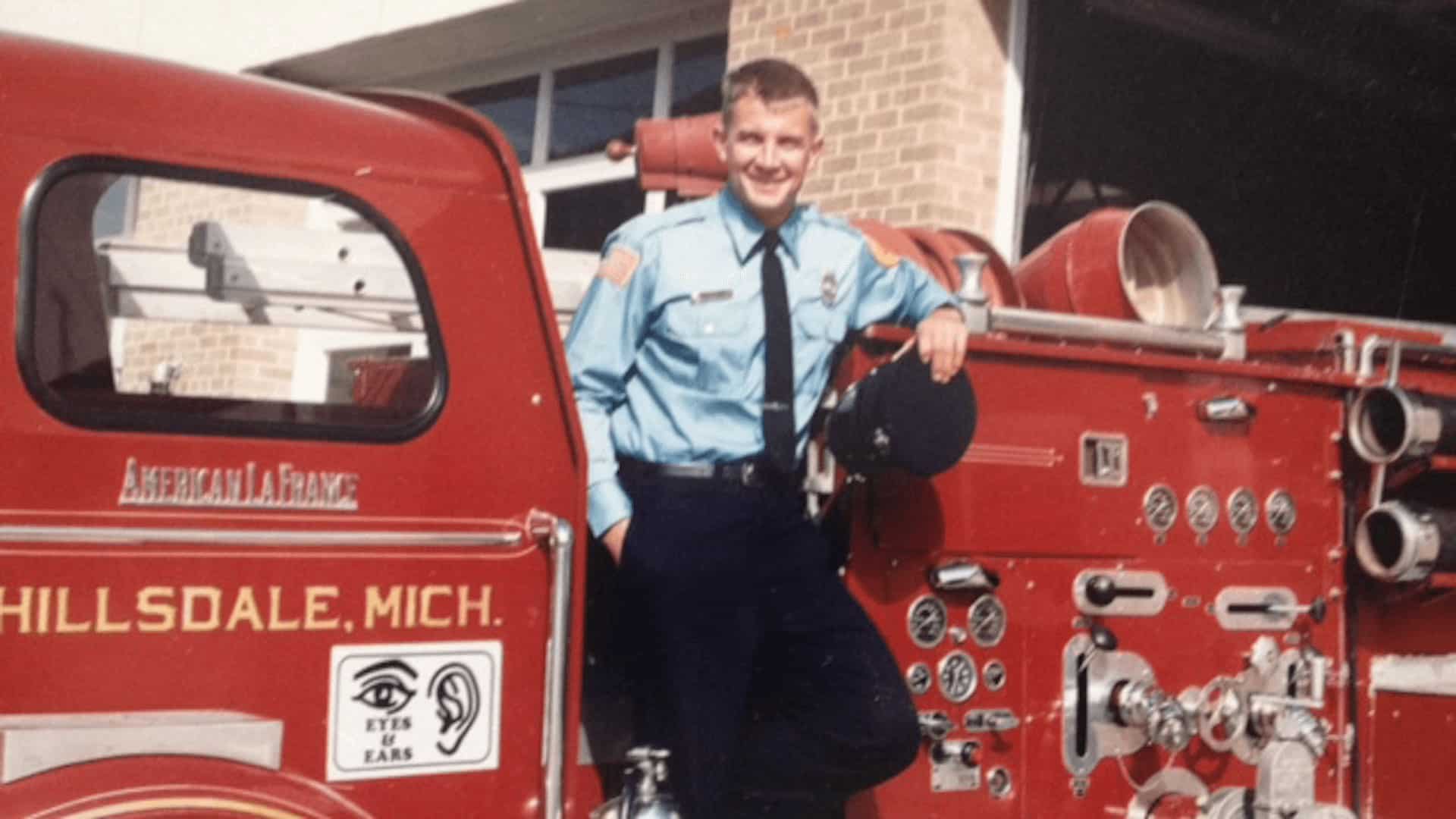 Erik Prince standing in front of a firetruck.