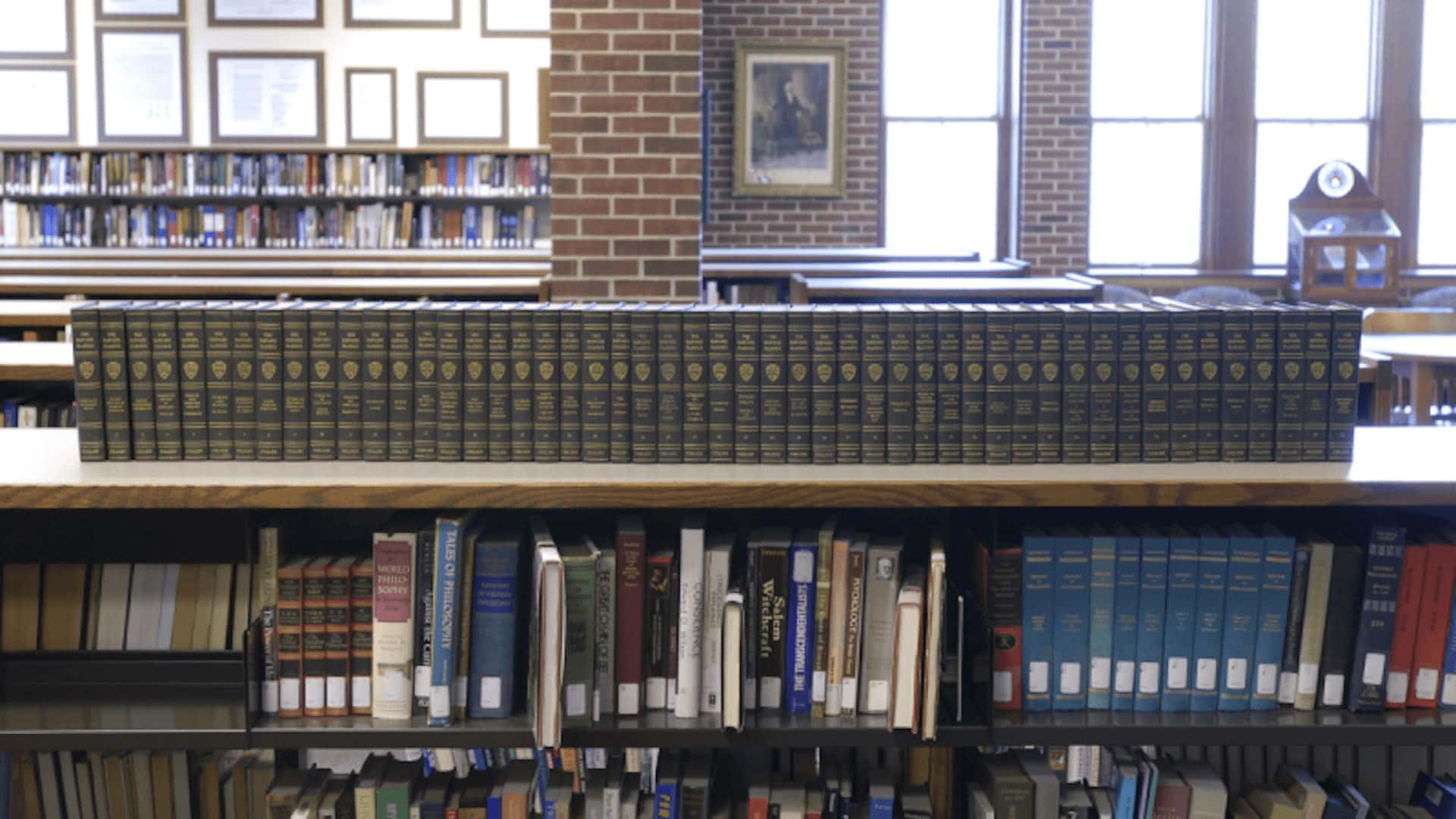 A large book collection sitting on a shelf in the Hillsdale College library.