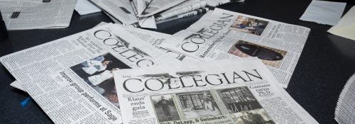 Several Collegian newspapers on a table.