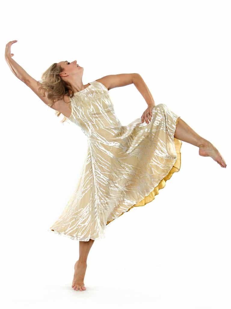 Holly Hobbs dancing in a silver and gold dress.