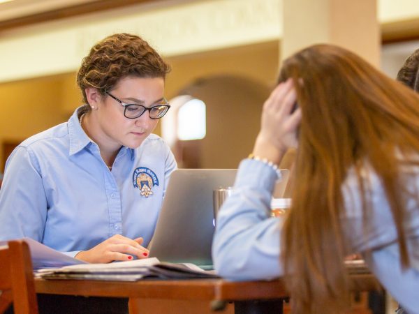 A pair of students studying in the library.