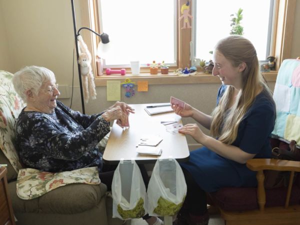 Hillsdale student playing cards with residents of an assisted living facility.