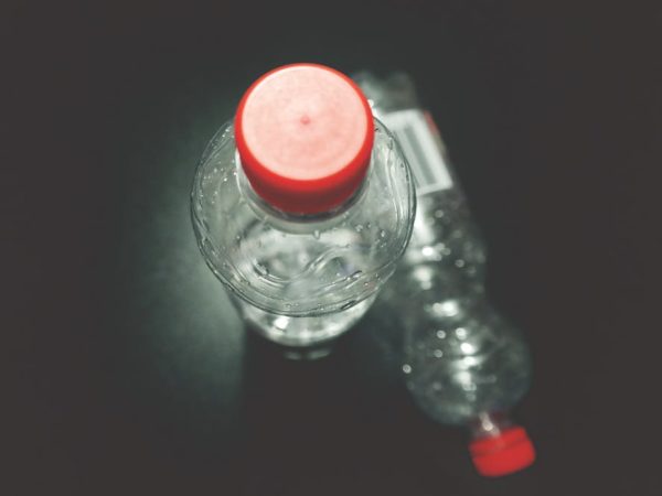 Closeup, top-down view of two plastic water bottles.