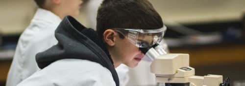 academy student with microscope