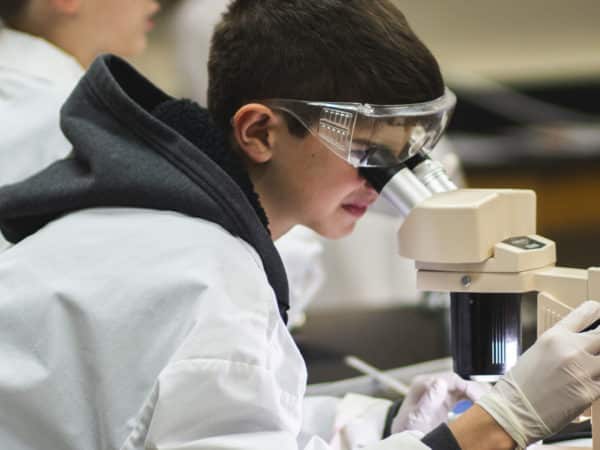 academy student with microscope