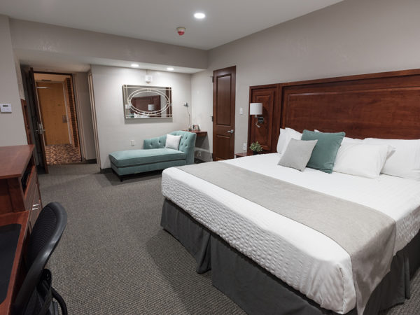An inviting hotel room with a made bed at the Dow Center