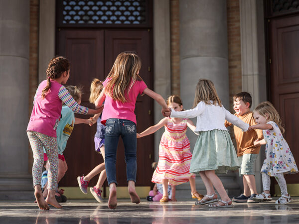 Young children play in front of Christs Chapel